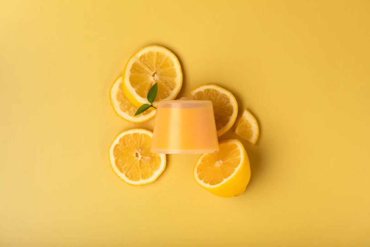 Luscentra citrus vitamin C capsule with sliced citrus on yellow.
