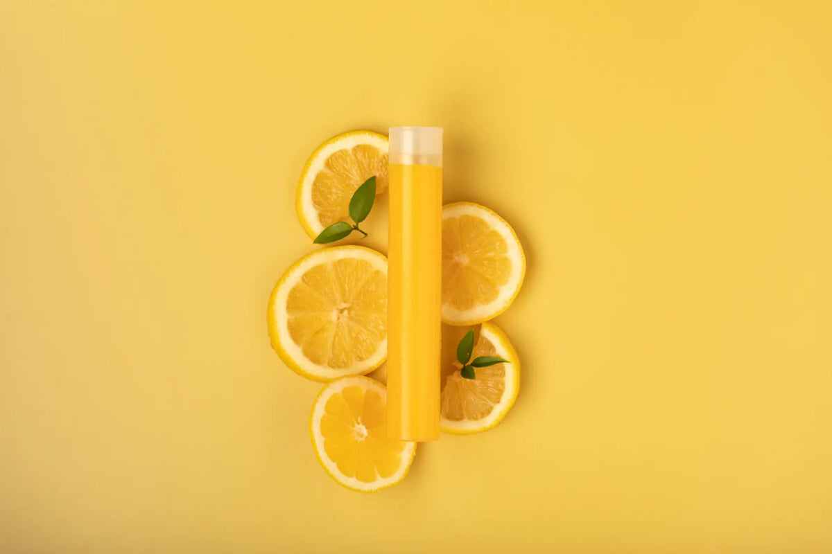Luscentra citrus vitamin C capsule with sliced citrus on yellow.