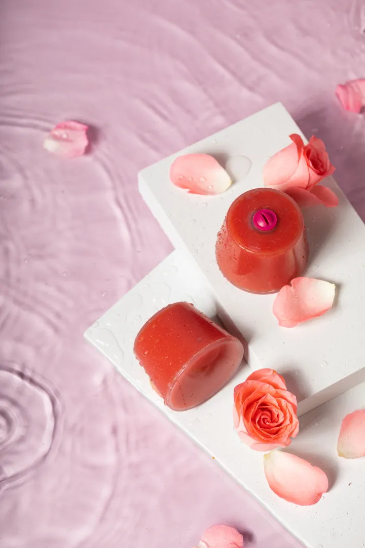Luscentra rose vitamin C capsule styled with roses on pink.