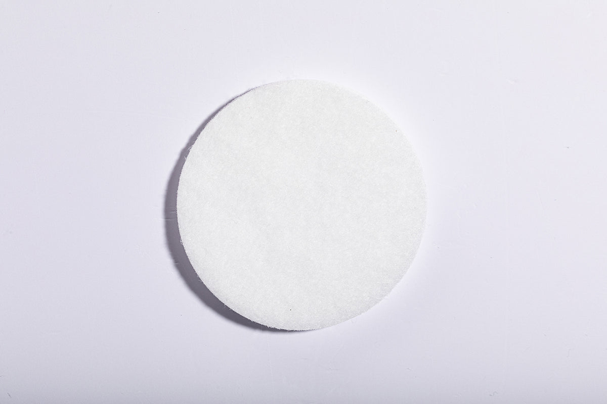 The round white microfibre filter used in a Luscentra showerhead.