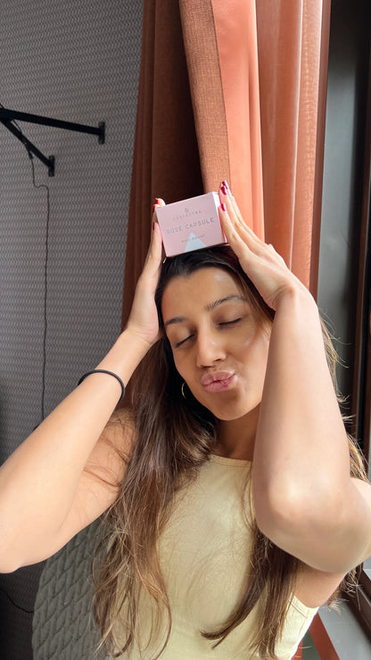 Person holding a Luscentra vitamin C shower-capsule package.