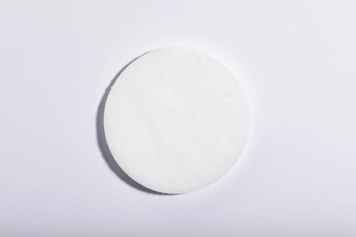 Round white Luscentra microfibre shower-filter cloth.
