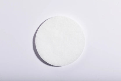 Round white Luscentra microfibre shower-filter cloth.
