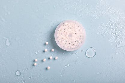 Luscentra antibacterial ceramic shower-filter balls on blue tile.