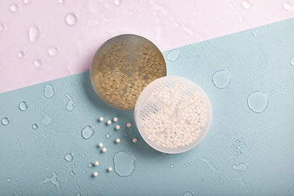 Luscentra antibacterial ceramic shower-filter balls on blue tile.