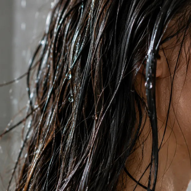 Wet hair strands with water droplets.